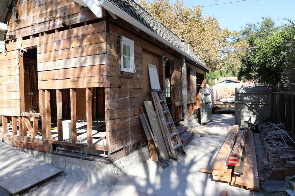 Willow Glen home renovation showing exterior walls removed with damaged wooden framing being replaced due to rot and water damage.